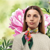 Woman wearing a colorful scarf with floral design against a floral background