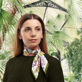 Woman wearing a colorful scarf with a tropical background