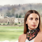 Woman wearing a Fossil Silk Twill scarf with a Chatsworth background and greenery.