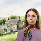 Woman wearing a colorful scarf with a scenic village background