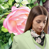 Woman wearing a floral silk twill scarf with a pink rose in the background