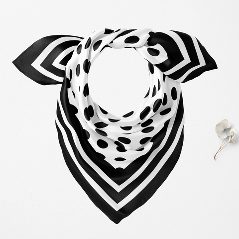 Black and white patterned scarf on a light gray background