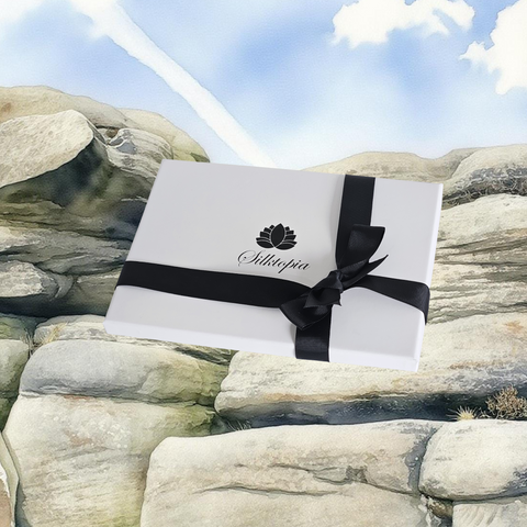 White box with a black ribbon on a rocky, Peak District background.