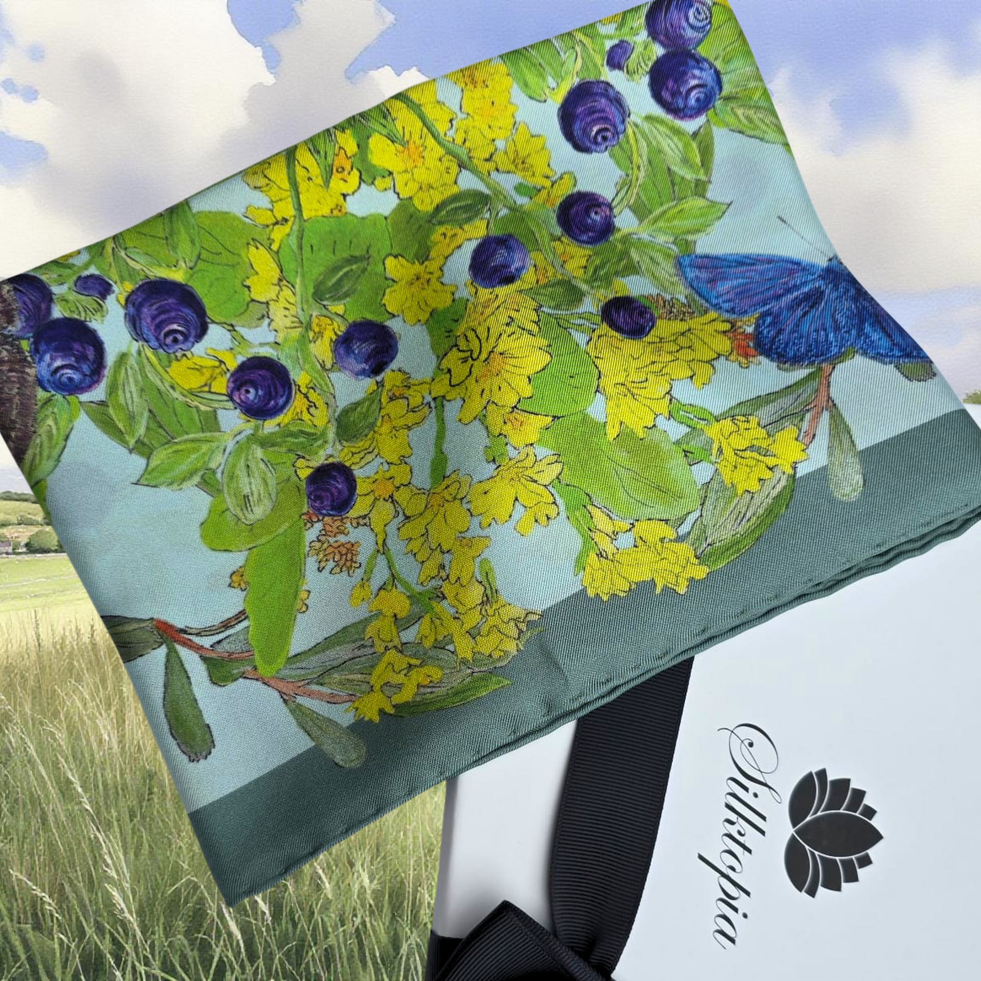 floral design featuring blueberries and a butterfly, set against a scenic background.