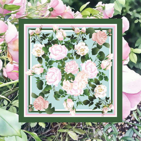 Floral patterned fabric square surrounded by pink flowers and green leaves