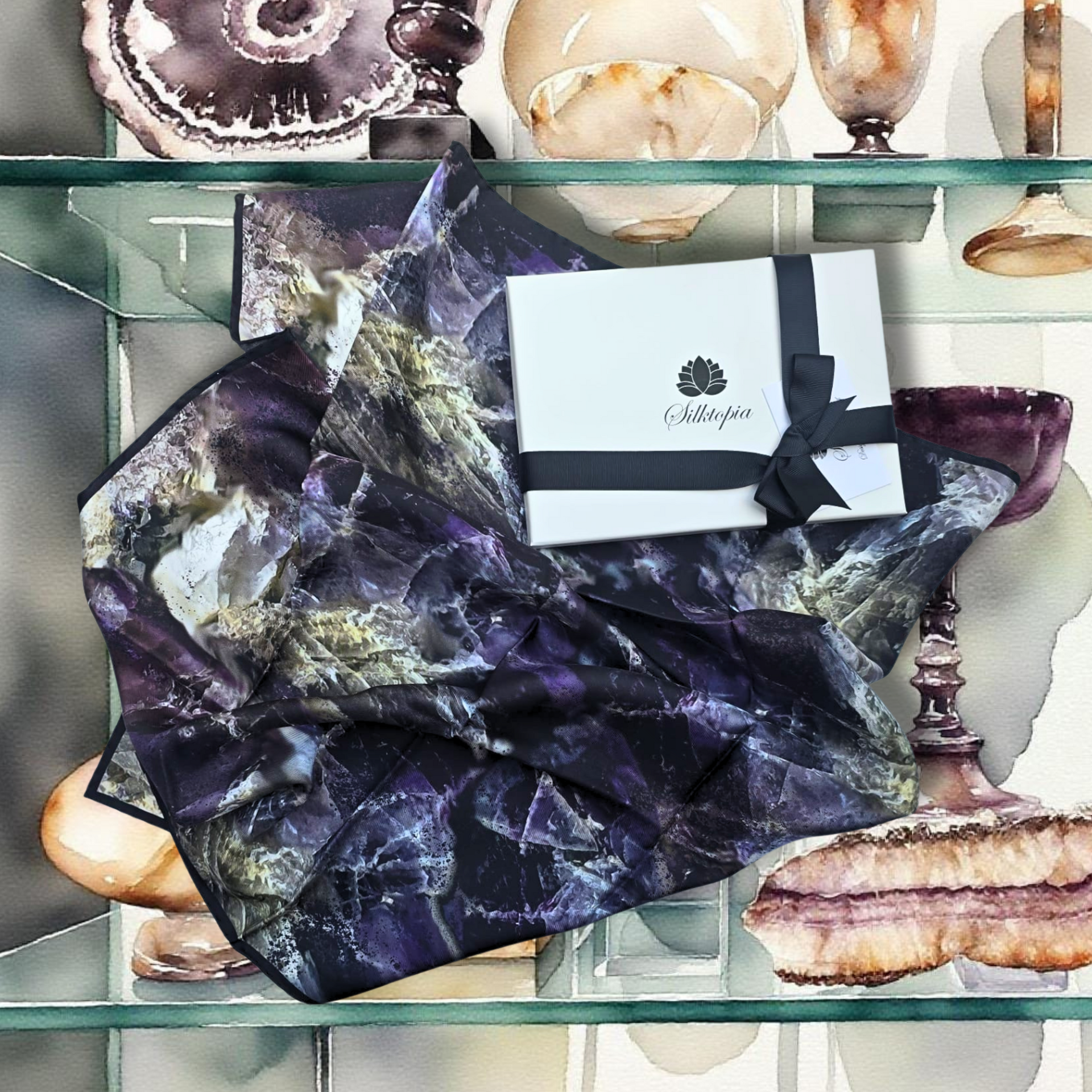 Decorative purple and black stone on a glass shelf with a gift box and decorative items.