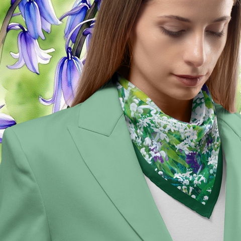 Woman wearing a green floral scarf with a blurred background of flowers
